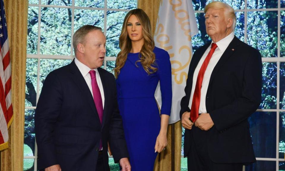 The waxwork of Melania Trump with her husband Donald at the Times Square Tussauds in New York. The real Sean Spicer looks on.