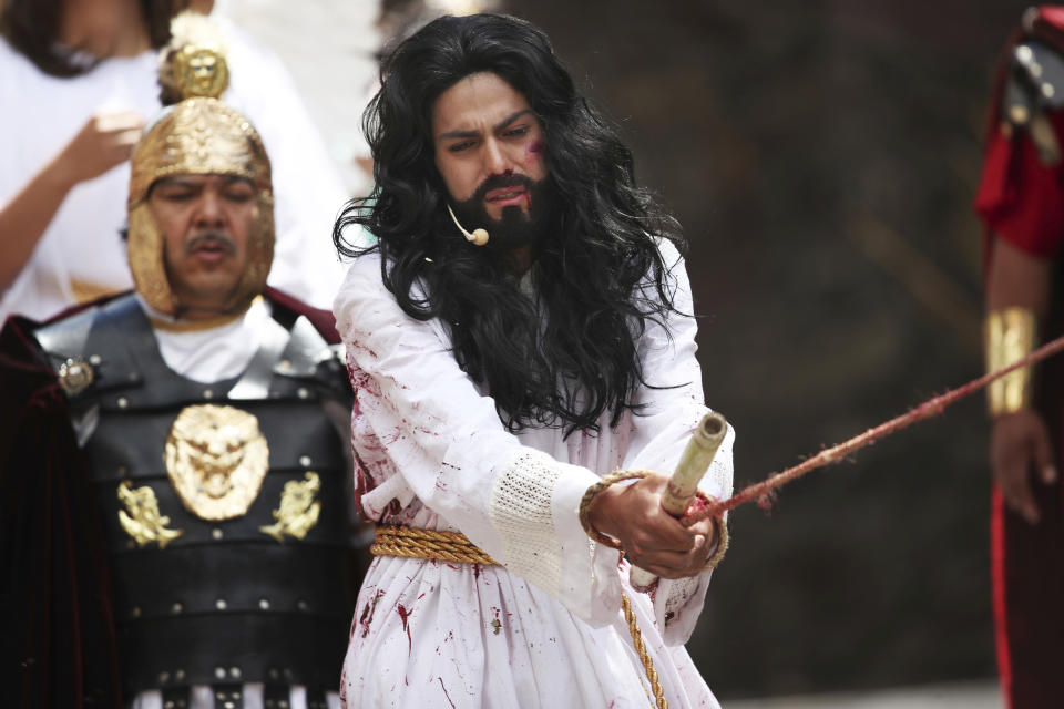 Brando Neri Luna reenacts the role of Jesus Christ in the Passion Play of Iztapalapa, outside the Cathedral, on the outskirts of Mexico City, Friday, April 2, 2021, amid the new coronavirus pandemic. To help prevent the spread of the COVID-19, Latin America's most famous re-enactment of the crucifixion of Christ was closed to the public and transmitted live so people could watch at home, for a second consecutive year. (AP Photo/Marco Ugarte)