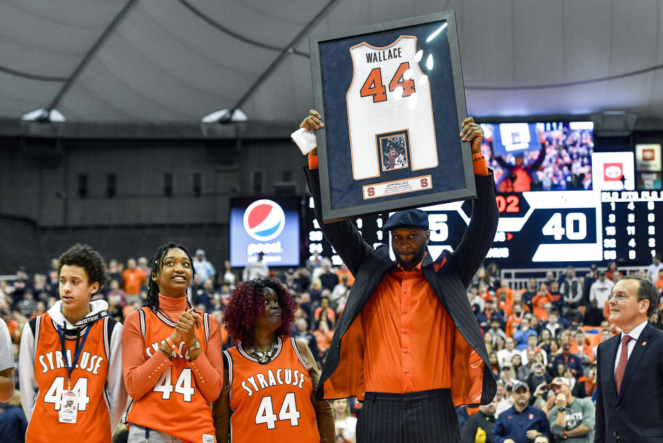 Former Syracuse player John Wallace has his jersey retired during halftime of an NCAA college basketball game between Syracuse and North Carolina in Syracuse, N.Y., Saturday, Feb. 29, 2020. (AP Photo/Adrian Kraus)