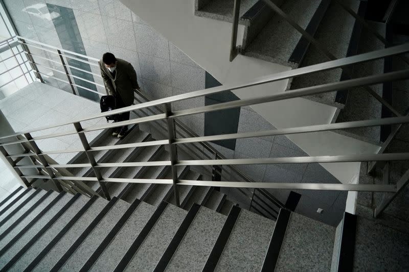 A professor of Pusan National University Park Hyun who used to be a coronavirus patient, takes a deep breath while walking up the stairs at Pusan National University in Busan