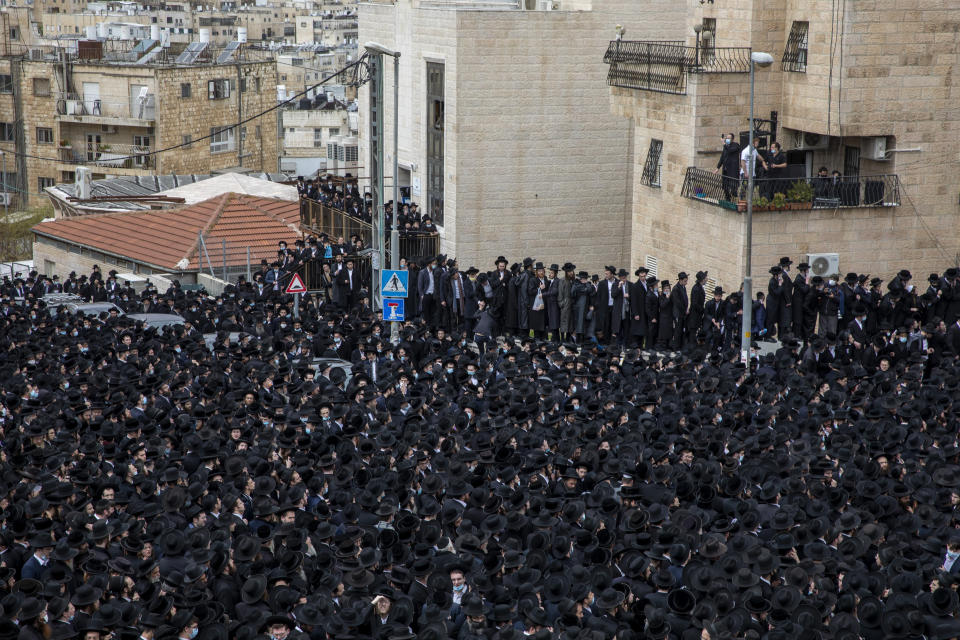 Thousands of ultra-Orthodox Jews participate in the funeral for prominent rabbi Meshulam Soloveitchik, in Jerusalem, Sunday, Jan. 31, 2021. The mass ceremony took place despite the country's health regulations banning large public gatherings, during a nationwide lockdown to curb the spread of the virus. (AP Photo/Ariel Schalit)