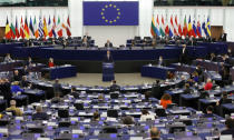 Poland's Prime Minister Mateusz Morawiecki, center, delivers his speech Tuesday, Oct. 19, 2021 at the European Parliament in Strasbourg, eastern France. The European Union's top official locked horns Tuesday with Poland's prime minister, arguing that a recent ruling from the country's constitutional court challenging the supremacy of EU laws is a threat to the bloc's foundations and won't be left unanswered. (Ronald Wittek, Pool Photo via AP)