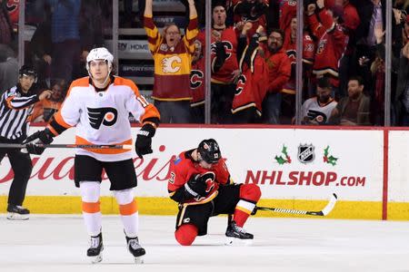 Dec 12, 2018; Calgary, Alberta, CAN; Calgary Flames left wing Johnny Gaudreau (13) celebrates his game-winning goal in overtime over the Philadelphia Flyers at Scotiabank Saddledome. Mandatory Credit: Candice Ward-USA TODAY Sports