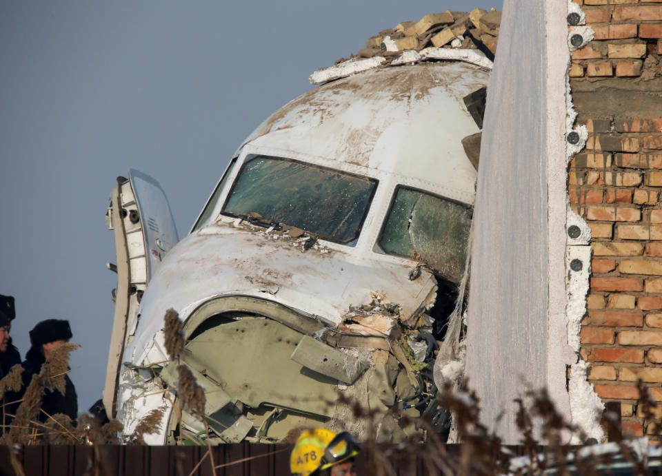 Emergency and security personnel are seen at the site of the plane crash near Almaty, Kazakhstan, December 27, 2019. REUTERS/Pavel Mikheyev