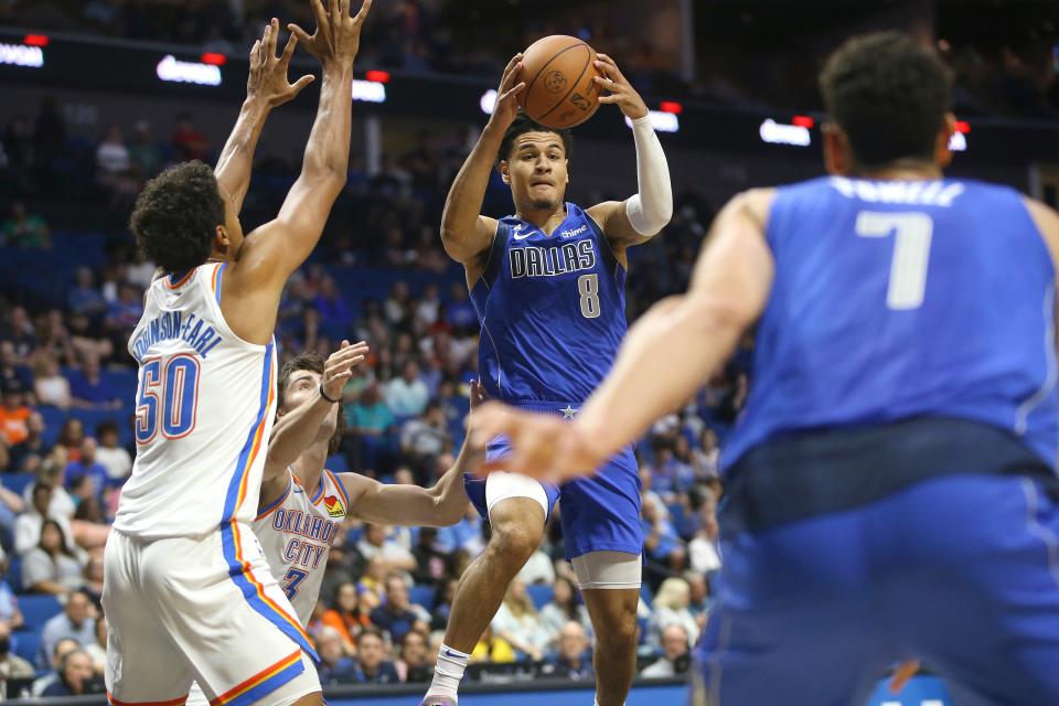 Dallas Mavericks' Josh Green looks to pass as Oklahoma City Thunder's Jeremiah Johnson-Earl defends during the first half of a preseason NBA basketball game in Tulsa, Okla., Wednesday, Oct. 5, 2022. (AP Photo/Dave Crenshaw)