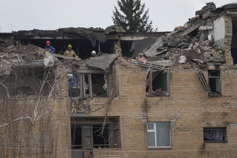 Emergency personnel work at the scene following a drone attack in the town of Rzhyshchiv, Kyiv region, Ukraine, Wednesday, March 22, 2023. (AP Photo/Efrem Lukatsky)