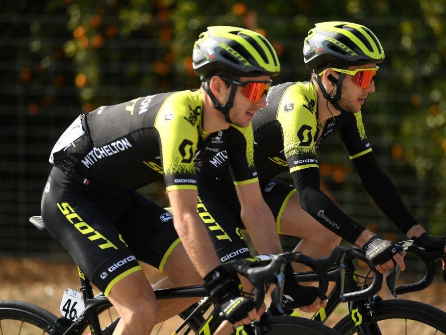 Adam and Simon Yates riding bikes next to each other