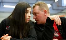 Syrian swimmer Yusra Mardini (L) talks to her coach Sven Spannekrebs of Wasserfreunde Spandau 04 during a news conference in Berlin, Germany March 18, 2016. REUTERS/Fabrizio Bensch