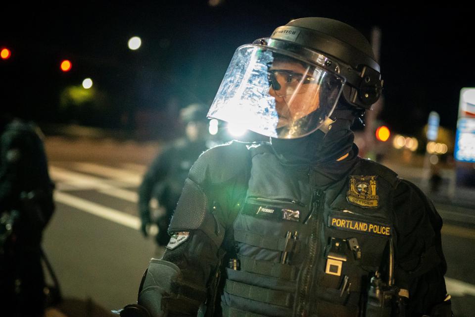 Portland police disperse a crowd after protesters set fire to the Portland Police Association (PPA) building early in the morning on 29 August, 2020 in Portland, Oregon.  (Getty Images)