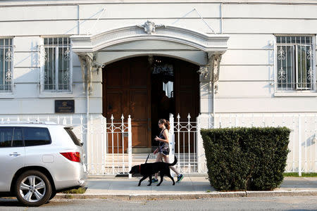 A dog walker walks with her dog outside the Consulate General of Russia in San Francisco, California, U.S., September 2, 2017. REUTERS/Stephen Lam