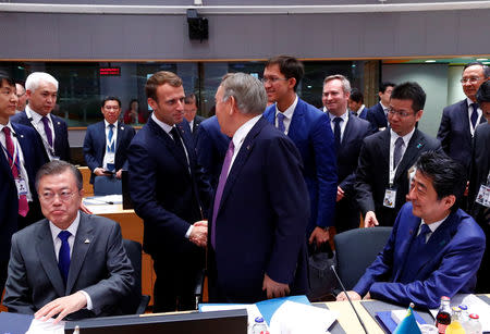 Kazakhstan's President Nursultan Nazarbayev and French President Emmanuel Macron shake hands as they attend the ASEM leaders summit in Brussels along with South Korea's President Moon Jae-in and Japan's Prime Minister Shinzo Abe, Belgium October 19, 2018. REUTERS/Francois Lenoir