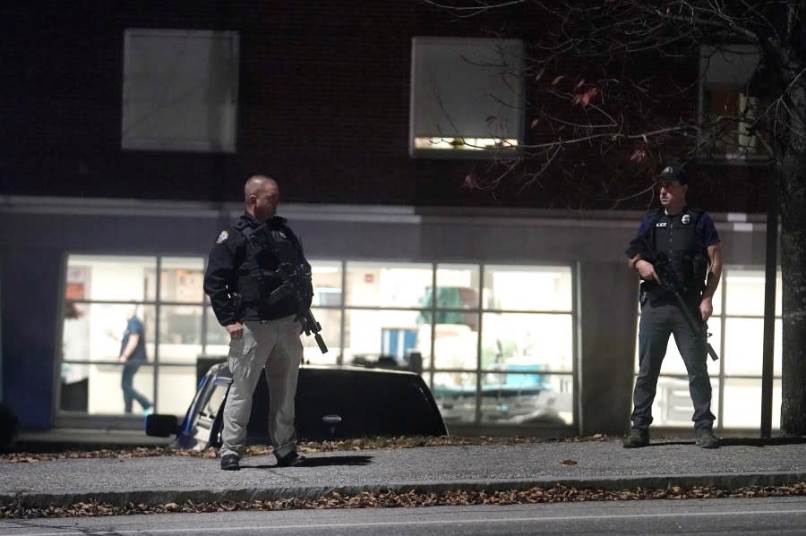 Law enforcement officers carry rifles outside Central Maine Medical Center during an active shooter situation, in Lewiston, Maine, Wednesday, Oct. 25, 2023. (AP Photo/Steven Senne)