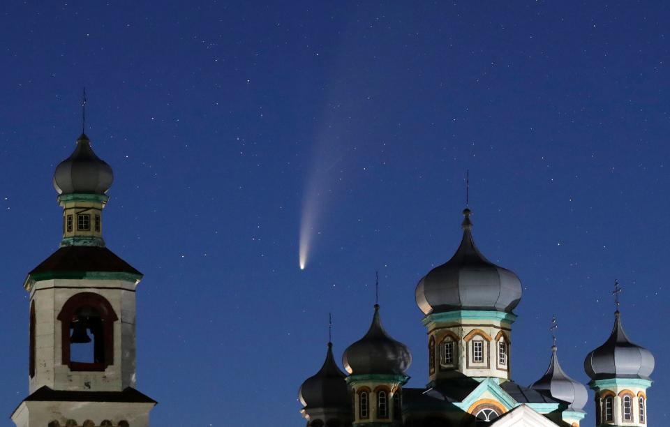 Comet Neowise is seen behind an Orthodox church over the Turets, Belarus, 69 miles west of capital Minsk, early Tuesday, July 14, 2020.