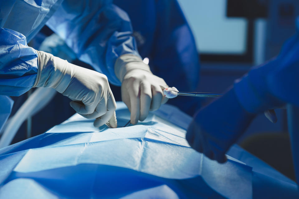 Close-up of surgeon with nurse and and assistant during operation in operating room.