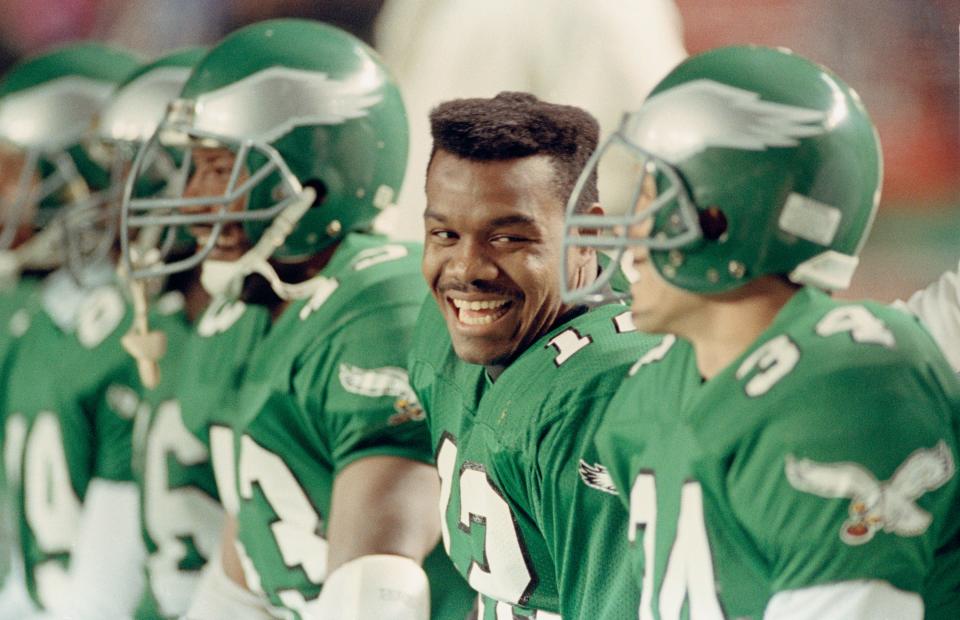 Philadelphia Eagles quarterback Randall Cunningham laughs with teammates on the bench in the closing minutes of the Eagles 28-14 win over Washington in 1990.