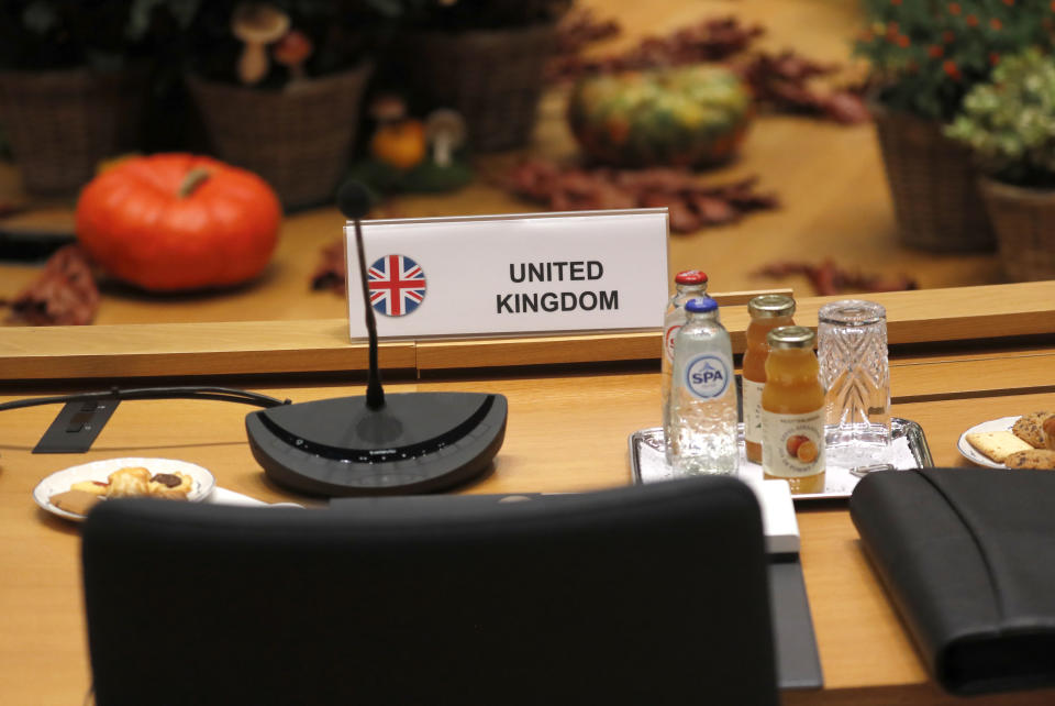 An empty chair for the British delegation during a round table meeting at EU summit in Brussels, Friday, Oct. 18, 2019. After agreeing on terms for a new Brexit deal, European Union leaders are meeting again to discuss other thorny issues including the bloc's budget and climate change. (AP Photo/Frank Augstein)