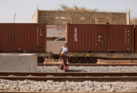 A woman walks along newly built tracks of the high speed railway in Mbao, on the outskirts of Dakar, Senegal February 12, 2019. Picture taken February 12, 2019. REUTERS/Zohra Bensemra