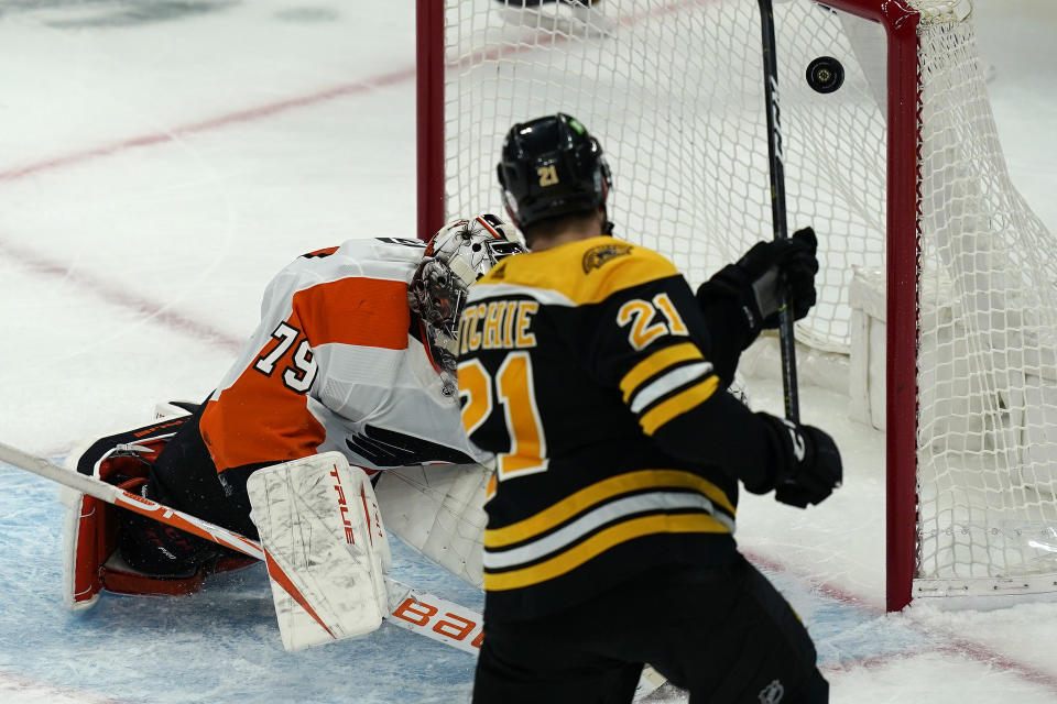 Boston Bruins left wing Nick Ritchie (21) scores against Philadelphia Flyers goaltender Carter Hart (79) in the third period of an NHL hockey game, Thursday, Jan. 21, 2021, in Boston. (AP Photo/Elise Amendola)