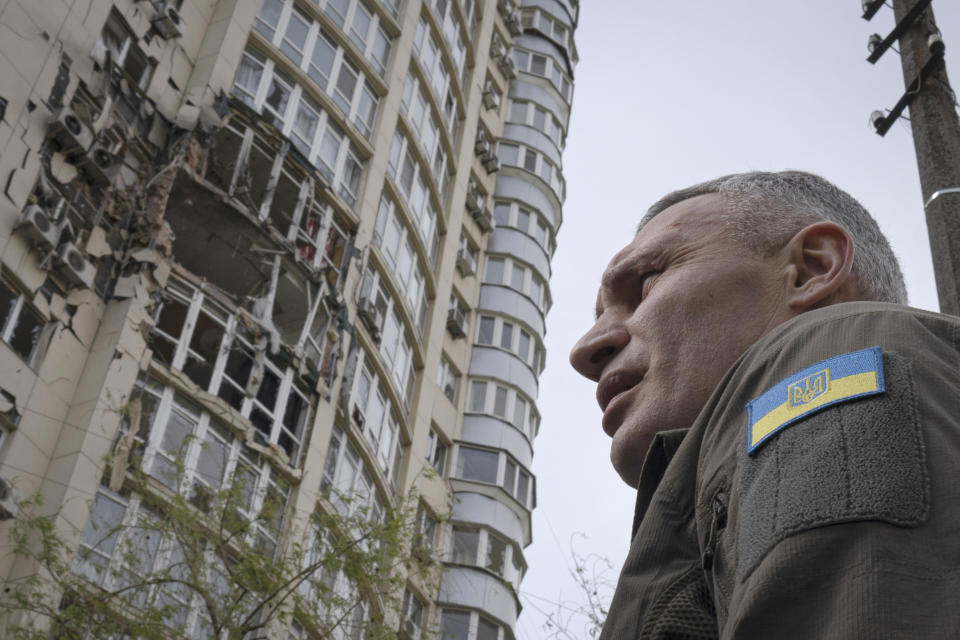Kyiv Mayor Vitali Klitschko stands in front of an apartment building damaged by a drone that was shot down during a Russian overnight strike, amid Russia's attack, in Kyiv, Ukraine, Monday, May 8, 2023. (AP Photo/Andrew Kravchenko)