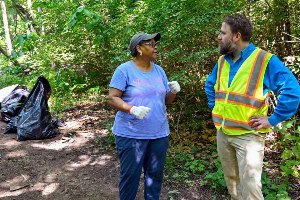 The Rev. Stacy Evans talks with Adam Benfer, an adjunct professor at Johnson County Community College, as the pair participated in a cleanup event at the Quindaro Ruins.