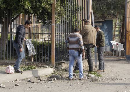 Egyptian security officials inspect the site of a bomb blast near the Alf Maskan district of Cairo, January 25, 2015. REUTERS/Mohamed Abd El Ghany