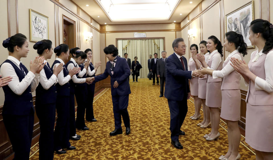 South Korean President Moon Jae-in, center right, and his wife Kim Jung-sook, shake hands with staff of Paekhwawon State Guesthouse before leaving for the Mount Paektu, in Pyongyang, North Korea, Thursday, Sept. 20, 2018. (Pyongyang Press Corps Pool via AP)