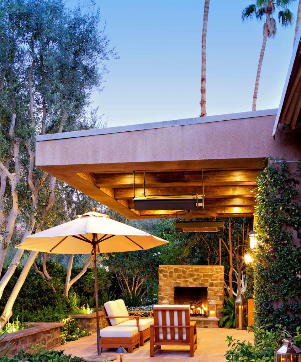 covered patio with lighting and outdoor fireplace