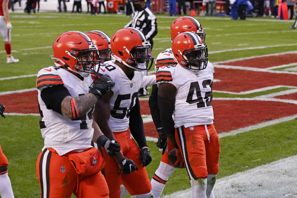 Cleveland Browns safety Karl Joseph (42) celebrates with teammates after intercepting a pass during the second half of an NFL divisional round football game against the Kansas City Chiefs, Sunday, Jan. 17, 2021, in Kansas City. (AP Photo/Charlie Riedel)