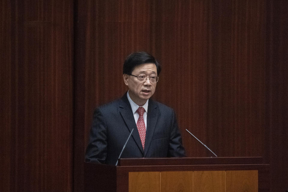 Hong Kong Chief Executive John Lee delivers his policy address at the chamber of the Legislative Council in Hong Kong, Wednesday, Oct. 19, 2022. Hong Kong's leader on Wednesday unveiled a new visa scheme to woo global talent, as the city seeks to stem a brain drain that has risked its status as an international financial center. (AP Photo/Vernon Yuen)