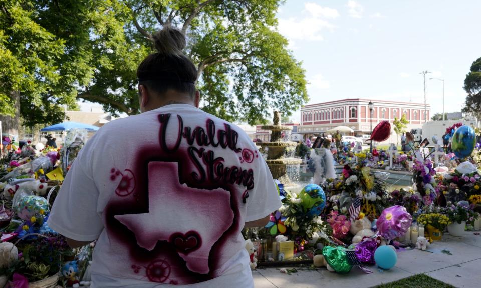 A person mourns at the Uvalde memorial