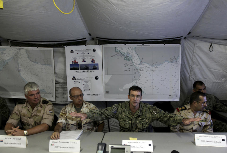 U.S. Navy Rear Adm. Kenneth Perry gestures while briefing journalists at the U.S. Navy base in Manama, Bahrain, on Thursday, Sept. 20, 2012, about a major exercise involving air, sea and undersea forces from more than 20 nations responding to simulated sea-mine attacks in international waters. The sea maneuvers, a demonstration of international resolve to ensure maritime security, are being held in the Persian Gulf, the Gulf of Oman and the Gulf of Aden. Seated left to right at front table are Dutch Cmdr. Johan den Arend, Italian Capt. Andrea Mucedola, Perry and Iraqi Rear Adm. Hameed Behadili. (AP Photo/Hasan Jamali)