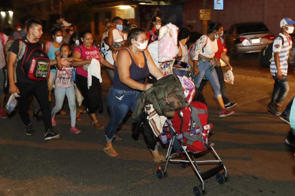 Migrants walk along a highway in hopes of reaching the distant United States, in San Pedro Sula, Honduras, Wednesday, Sept. 30, 2020. Hundreds of migrants have begun walking from this northern Honduras city toward the Guatemala border testing a well-trod migration route now in times of the new coronavirus. (AP Photo)