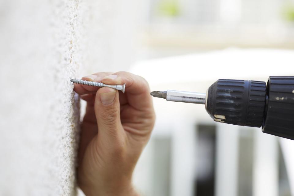 Safely drilling into a wall.