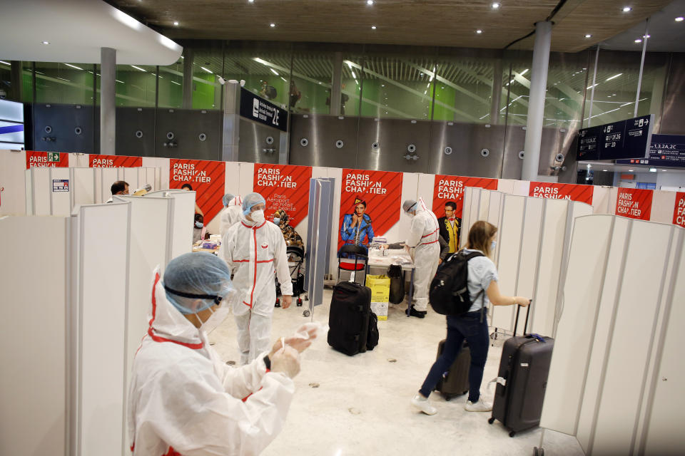 A passenger leaves after being tested with a COVID-19 test, at the Roissy Charles de Gaulle airport, outside Paris, Saturday, Aug. 1, 2020. Travelers entering France from 16 countries where the coronavirus is circulating widely are having to undergo virus tests upon arrival at French airports and ports.(AP Photo/Thibault Camus)