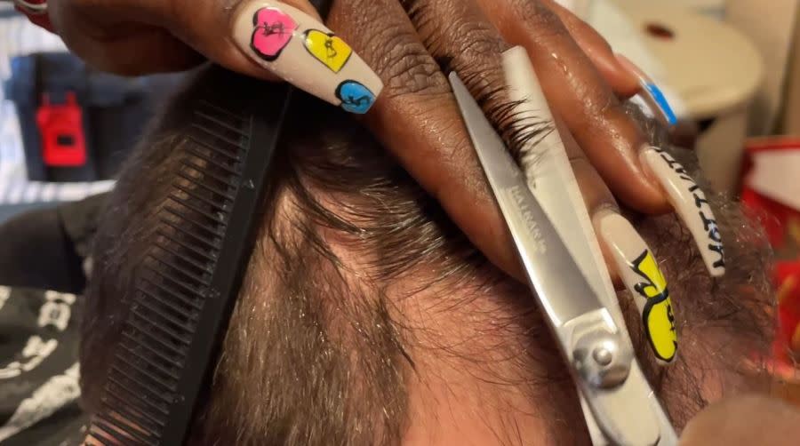 Leathers cutting her client’s hair (Chloe Rafferty/CBS 17)