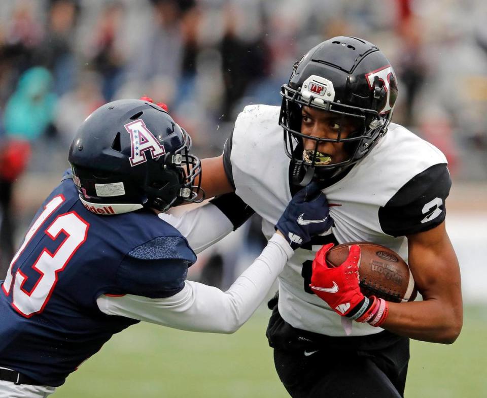 Allen defensive back Caden Dunlap (13) grabs Trinity quarterback Ollie Gordon (2) during a high school Class 6A Division 1 Regional playoff game at Eagle Stadium in Allen, Texas, Saturday, Nov. 27, 2021. Allen led 38-7 at the half. (Special to the Star-Telegram Bob Booth)