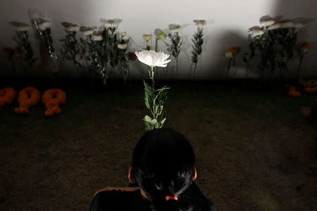 A mourner pays her respects to the late King Bhumibol Adulyadej along the Grand Palace walls in Bangkok,Thailand October 20, 2016. REUTERS/Chaiwat Subprasom