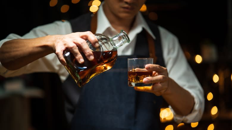 bartender pouring whiskey