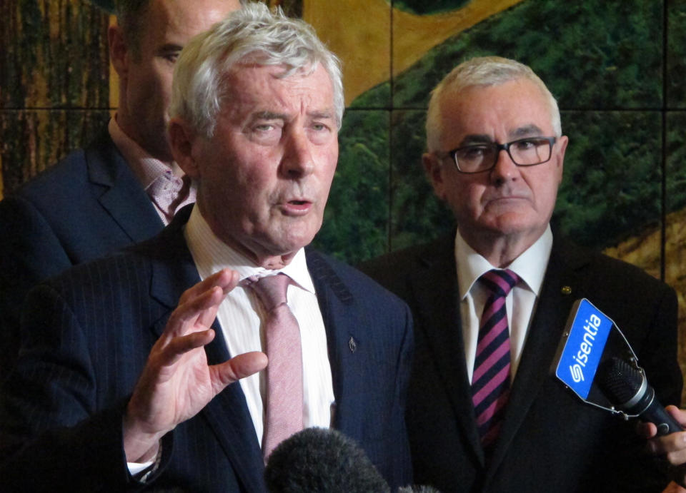 FILE - In this June 28, 2018, file photo, lawyer Bernard Collaery, left, addresses the media as lawmaker Andrew Wilkie, right, looks on in Parliament House in Canberra, Australia. A former Australian spy was released from court on Friday, June 18, 2021, with a three-month suspended prison sentence over his attempt to help East Timor prove that Australia spied on the fledgling nation during multi-billion dollar oil and gas negotiations. The former spy publicly known as Witness K and his lawyer Collaery had been charged in 2018 with conspiring to reveal secret information to the East Timorese government. (AP Photo/Rod McGuirk, File)