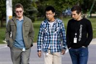 Men wearing employee tags walk on the sidewalk in front of the BlackBerry campus in Waterloo September 23, 2013. REUTERS/Mark Blinch