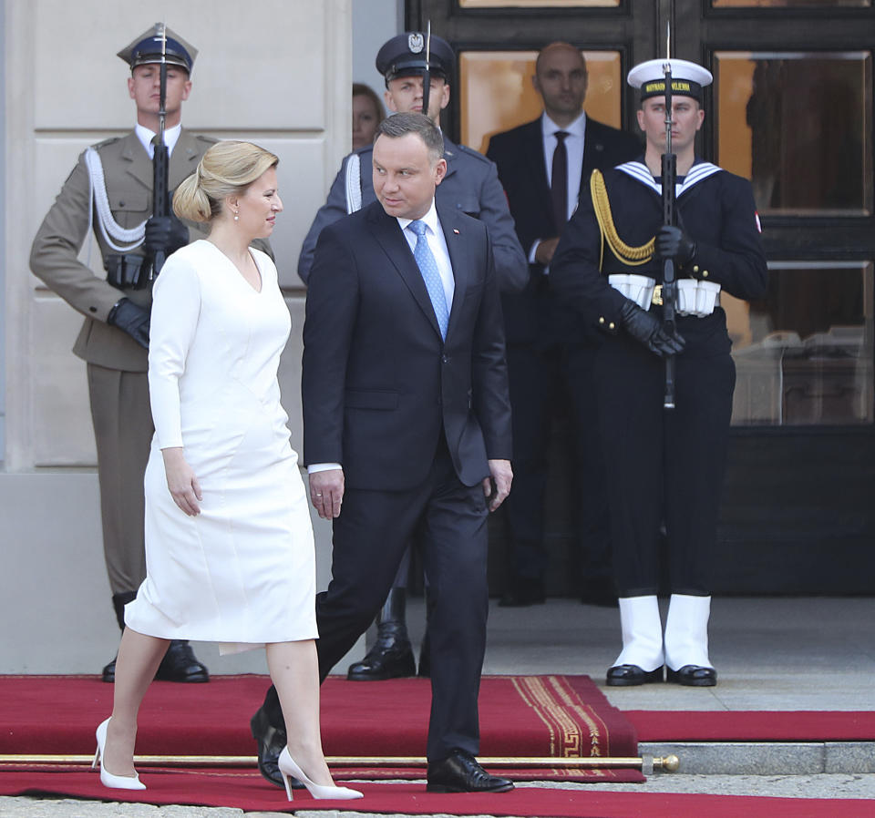 Polish President Andrzej Duda, right, and Slovakian President Zuzana Caputova, left, attend a military welcome ceremony at the presidential Palace in Warsaw, Poland, Monday, July 15, 2019. Caputova is staying for an official visit in Poland. (AP Photo/Czarek Sokolowski)