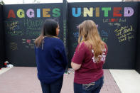 People write on a message wall during the "Aggies United" official school event outside Kyle Field at Texas A&M University, before a separate event not sanctioned by the school on campus where white nationalist leader Richard Spencer of the National Policy Institute is due to speak, in College Station, Texas, U.S. December 6, 2016. REUTERS/Spencer Selvidge