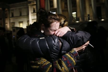 A woman cries during a vigil to pay tribute to the victims of a shooting by gunmen at the offices of weekly satirical magazine Charlie Hebdo in Paris, at Trafalgar Square in London January 7, 2015. REUTERS/Stefan Wermuth