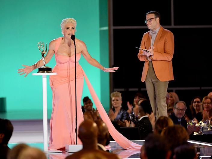 Hannah Waddingham on the Emmys stage with Seth Rogen standing next to her