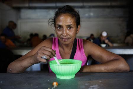 Monica Flores, 43, poses for a picture at the Mother Teresa of Calcutta eating center in Caracas April 8, 2014. REUTERS/Carlos Garcia Rawlins