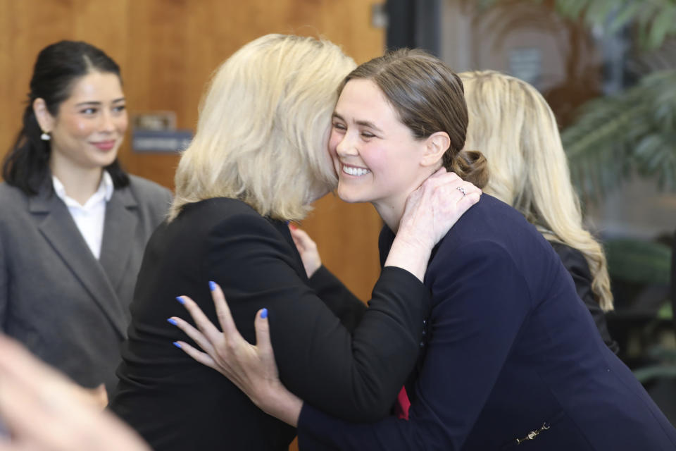 Taylor Shelton, right, who sued South Carolina over the definition of "heartbeat" under the state's 2023 abortion law hugs lawyer Malissa Burnette, left, on Thursday, May 2, 2024, in Columbia, S.C. (AP Photo/Jeffrey Collins)