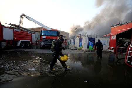 A firefighter is seen after a fire at a storage site in Baghdad, housing the boxes from Iraq's May parliamentary election, Iraq June 10, 2018. REUTERS/Thaier Al-Sudani