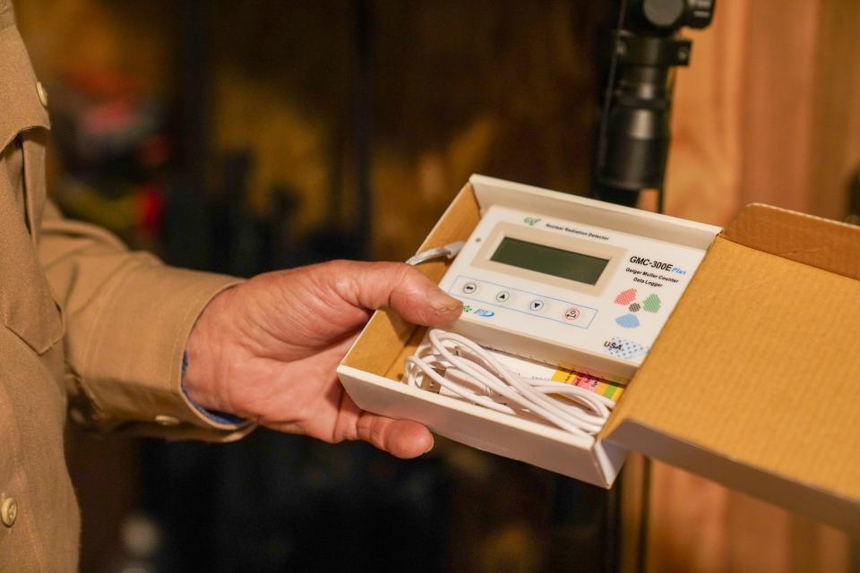 Drew Miller, a retired U.S. Air Force colonel, shows off a radiation detector at the southern Colorado location of Fortitude Ranch emergency preparedness or "prepper" community, which has multiple emergency shelters into which members can retreat during a societal collapse.