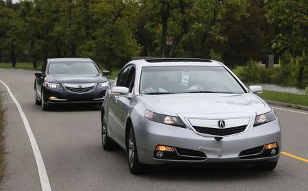 An Acura RLX sedan tows another with Honda's virtual tow technology that creates a wireless link between two cars, during a demonstration at the ITS World Congress in Detroit, Michigan, September 11, 2014. REUTERS/Rebecca Cook