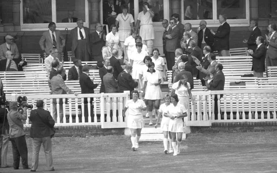 Rachael Heyhoe Flint (right) leading her England team onto the field at Lord's in 1976 - PA